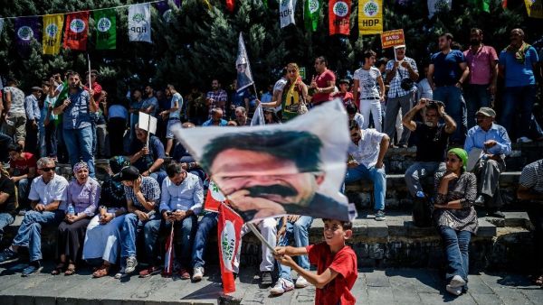 A boy waves a flag with a picture of the PKK's jailed leader Abdullah Ocalan at a rally in the Gazi district of Istanbul on July 23, 2016 (AFP/Ozan Kose)