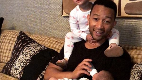 John Legend, 39, doted on his two young children Luna, two, and six-week-old son Miles in a clip his wife Chrissy Teigen, 31, posted to Instagram Friday (Instagram)