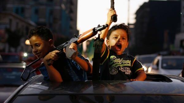 Palestinian children hold guns as they celebrate ceasefire agreement  (Twitter)