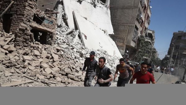 Syrians run for cover during reported government air strikes in the rebel-held town of Douma, east of the capital Damascus. (AFP/Abd Doumany)