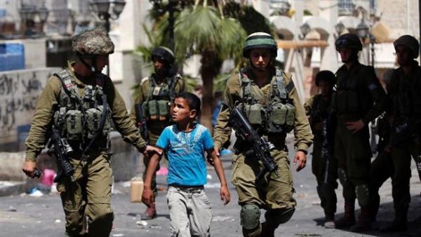 Israeli soldiers arrest a young Palestinian boy following clashes in the West Bank. (AFP/File) 
