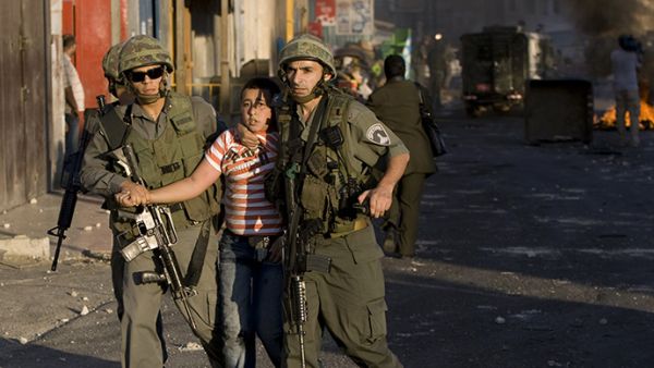 Israeli border policemen detain a Palestinian boy in the east Jerusalem Shuafat refugee camp. (AFP/Jonathan Nackstrand)