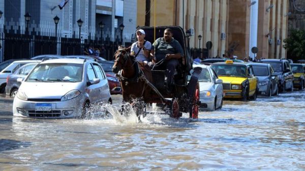 Egyptian men ride a horse carriage in a flooded street in Egypt's northern coastal city of Alexandria, following heavy rains, on October 25, 2015. (AFP/File)