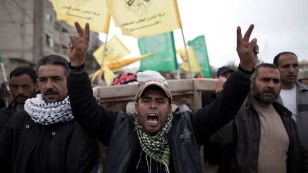 Palestinian mourners shout slogans as they carry the body of six-year-old Israa Abu Khussa during her funeral on March 12, 2016 in Beit Lahiya in the north of the Gaza Strip. (AFP/Mahmud Hams)
