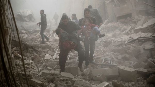 People evacuate victims following air strikes on Douma in the eastern Ghouta region. (AFP/File)  
