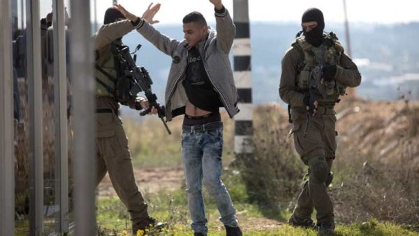 A Palestinian is checked by Israeli soldiers at the Gush Etzion junction on the main road between Jerusalem and Hebron. (AFP/File)