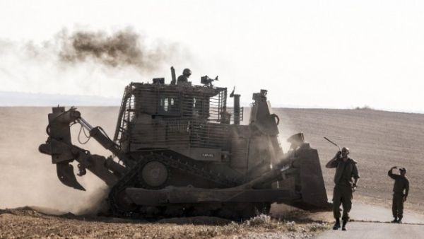 An Israeli D9 bulldozer rolls along the southern Israeli border with the Gaza Strip following Israeli airstrikes on the Gaza Strip on July 10, 2014. (AFP/Jack Guez)