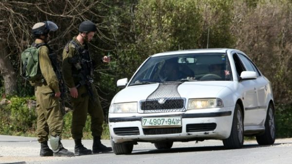 Israeli border guards check a driver near the Palestinian town of Qalqilya in the occupied West Bank. (AFP/Jaafar Ashtiyeh)
