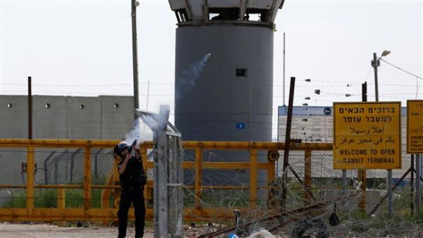 An Israeli soldier fires tear gas canisters towards Palestinian protesters outside the compound of the Israeli-run Ofer prison. (AFP/File) 