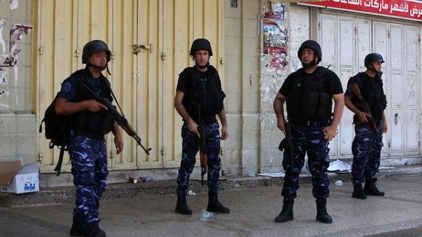 Palestinian security forces stand guard as riots take place in Nablus. (AFP/File) 
