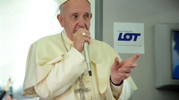 Pope Francis speaks to journalists during a press conference on the plane after his visit to Krakow for the World Youth Days, on July 31, 2016. (AFP/Filippo Monteforte)