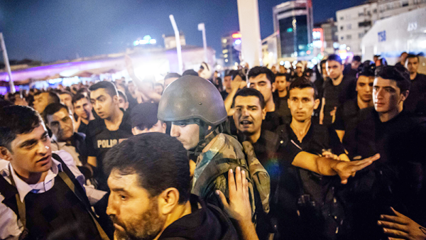 A Turkish solder is detained by police at Taksim square as people protest agaist the military. (AFP/File) 