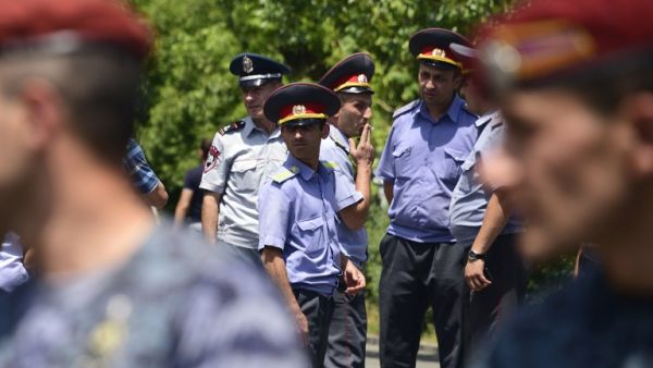 Armenian police officers stand guard as they block the streets to Erebuni police station in Yerevan on July 17, 2016. An armed group with links to an imprisoned opposition leader on July 17, 2016 seized a police building in Yerevan and took hostages, the national security service said. (AFP/Karen Minasyan) Armenian police officers stand guard as they block the streets to Erebuni police station in Yerevan on July 17, 2016. An armed group with links to an imprisoned opposition leader on July 17, 2016 seized a police building in Yerevan and took hostages, the national security service said. (AFP/Karen Minasyan)