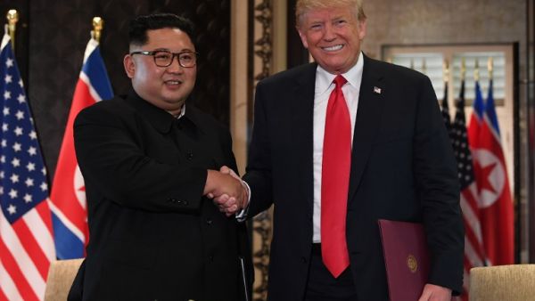 North Korea's leader Kim Jong Un (L) shakes hands with US President Donald Trump (R) after taking part in a signing ceremony at the end of their historic US-North Korea summit, at the Capella Hotel on Sentosa island in Singapore on June 12, 2018. (Anthony WALLACE / POOL / AFP)