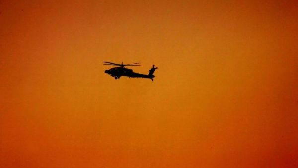 A military helicopter flies over the desert at Al-Hamra military camp, west of the Gulf emirate of Abu Dhabi. (AFP/File)
