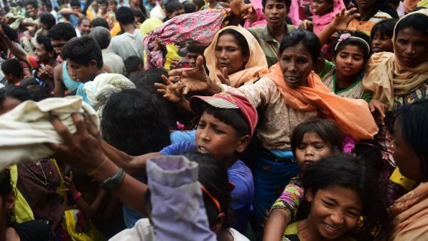 Newly arrived Rohingya refugees scuffle for relief supplies at Kutupalong refugee camp in the Bangladeshi locality of Ukhia on September 9, 2017 (Munir Uz Zaman/AFP)