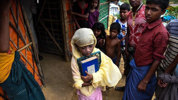 Saleema Khanam, 8, leaves her tent as she goes to a madrassa (Islamic seminary) for her studies in Kutupalong camp, in Ukhia near Cox's Bazar. (AFP)