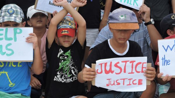 Refugee children take part in a protest in March 2015 against their resettlement on Nauru and living conditions on the island. (Amnesty International)