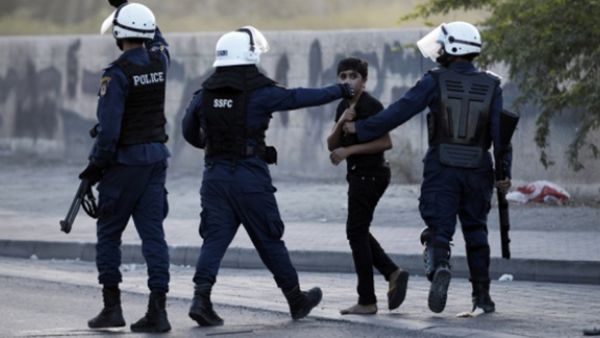 A Bahraini boy is arrested during clashes with riot police in the village of Daih, west of Manama on 19 June, 2014. (AFP)