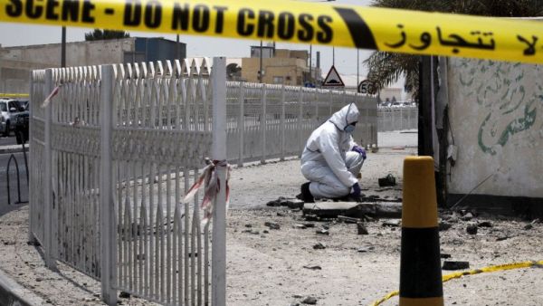 A Bahraini forensic police officer inspects the site of a bomb blast in the village of Sitra in 2015. (AFP/File) 