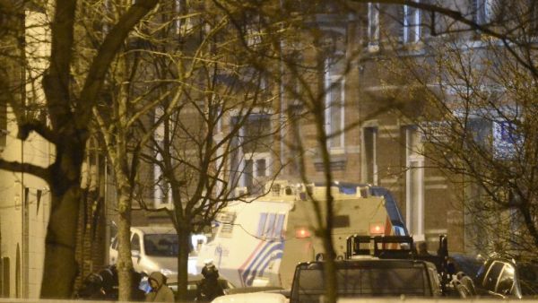 Police stand close to the suspects' apartment in the Forest district of Brussels, Belgium. (AFP/Dirk Waem)
