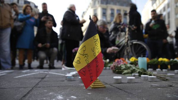 Mourners light candles and bring flowers to honor those killed in the Brussels attacks. (AFP/File)