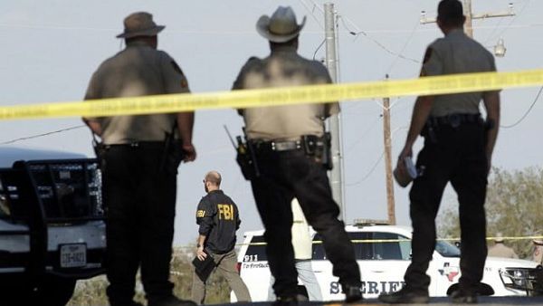 Law enforcement officials gather near the First Baptist Church following a shooting on November 5 (AFP)