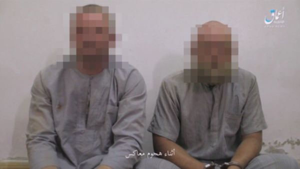 Speaking Russian and wearing matching grey outfits, the two men appear to have been beaten or injured with one showing a cut eye and bruises, in an Amaq video.