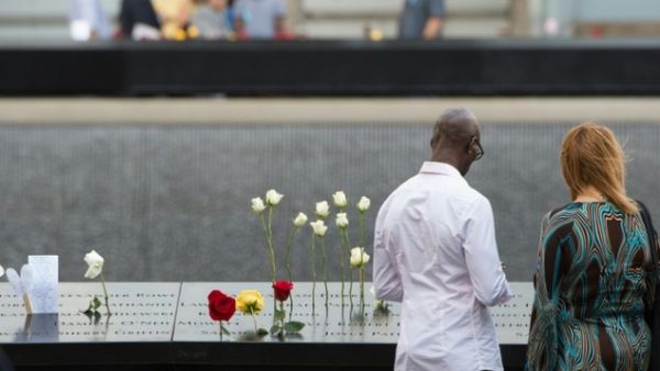 People look over the north memorial pool during the 15th anniversary of September 11 at the 9/11 Memorial and Museum, on September 11, 2016 in New York. (AFP/Bryan R. Smith)