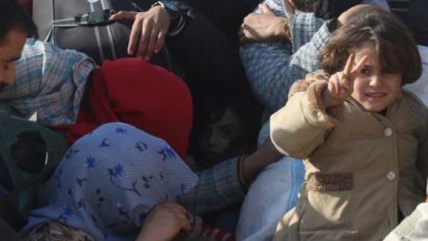 بعض ممن فروا مناطق القتال متكدسون في شاحنة بضاحية الأسد غرب حلب
