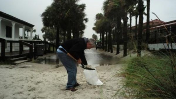 رجل يحضر كيس رمل تحسبا من الاعصار ماثيو، في جاكسونفيل بولاية فلوريدا، الخميس
