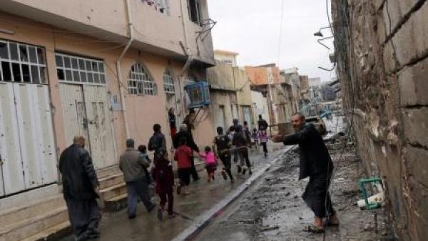 مدنيون يهرعون في احد شوارع الموصل عقب وقوع انفجار اثناء اشتباك بين القوات العراقية والدولة الاسلامية
