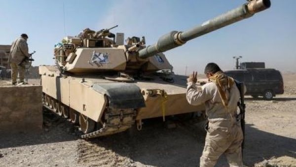 أحد أفراد قوات الأمن العراقية يوجه دبابة في الجزء المحرر من قرية أبو سيف جنوب الموصل 
