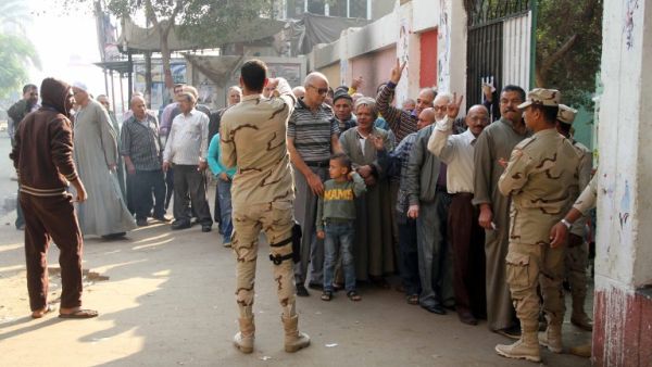 Men line up to vote at a polling station in Cairo on November 22, 2015. (AFP/STR)