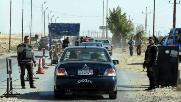 Egyptian police examine cars at a checkpoint in North Sinai. (AFP/File)