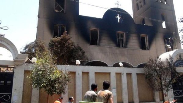 EGYPT, MINYA : A picture taken on August 14, 2013, shows the facade of the Prince Tadros Coptic church after being torched by unknown assailants in the central Egyptian city of Minya. AFP PHOTO/STR