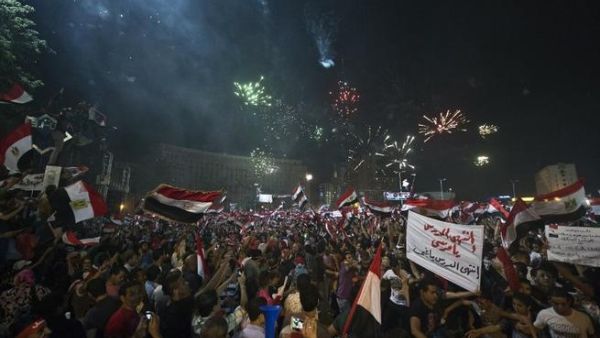 People celebrate in Tahrir Square after the army overthrew President Mohamed Morsi (AFP)