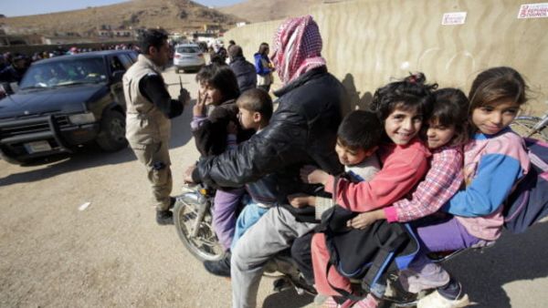 Syrians who fled recent violence in the mountainous Qalamoun region, waiting to be registered by the United Nations High Commissioner for Refugees (UNHCR) on November 19, 2013 in Arsal. [Getty Images]