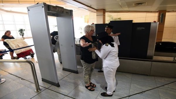 A tourist passes through the security check at Sharm El Sheikh Airport. (AFP/File)