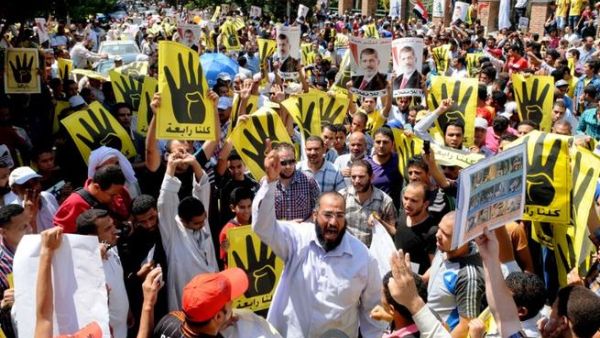 EGYPT, Cairo : Supporters of the Muslim Brotherhood and Egypt's toppled president Mohamed Morsi (portrait) take part in a demonstration in Hilwan, south of Cairo, on August 30, 2013.AFP PHOTO/STR