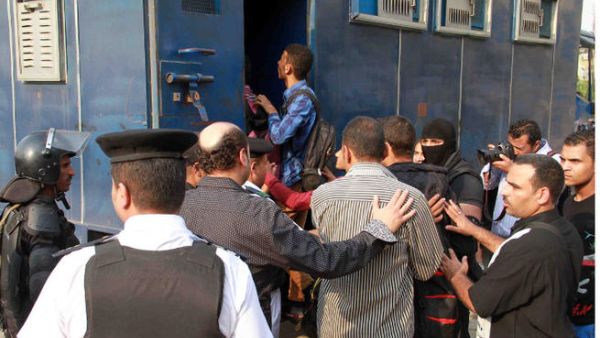 Egyptian policemen in plain clothes detain students of al-Azhar University in Cairo on October 30, 2013. (Image credit: AFP)