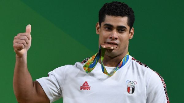 Egypt's Mohamed Mahmoud poses with his bronze medal on the podium of the Men's 77kg weightlifting competition at the Rio 2016 Olympic Games. (AFP/GOH Chai Hin)
