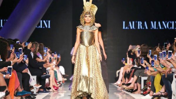 A model walks down the catwalk wearing a Laura Mancini design during the Arab Fashion Week in Dubai. (AFP)