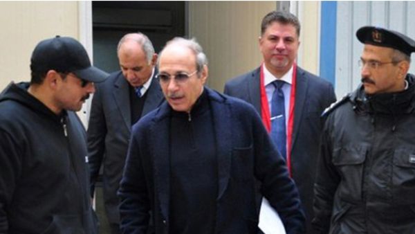 Egyptian former interior minister Habib al-Adly (c) walks outside the court room after his retrial at Cairo's police academy on February 24, 2015 (AFP)