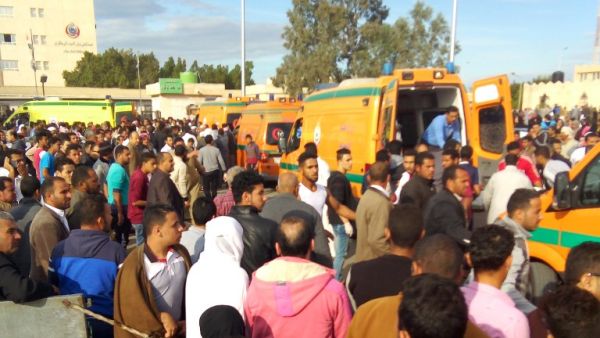 Egyptians gather around ambulances following a gun and bombing attack on the Rawda mosque near the North Sinai provincial capital of El-Arish on November 24, 2017 (AFP)