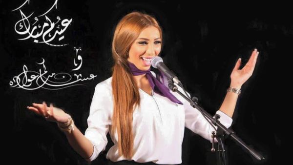 Dounia Batma at the microphone, doing what she does best. (Facebook)