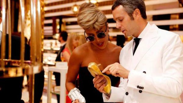 Maya Diab inspecting her gold-plated shoe (Image: Facebook)