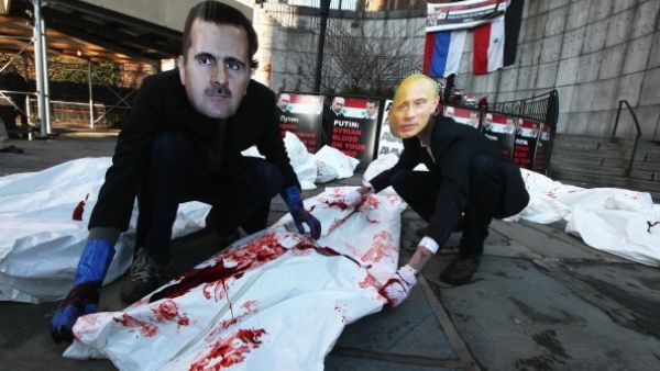 Activists dress up as the Syrian and Russian presidents