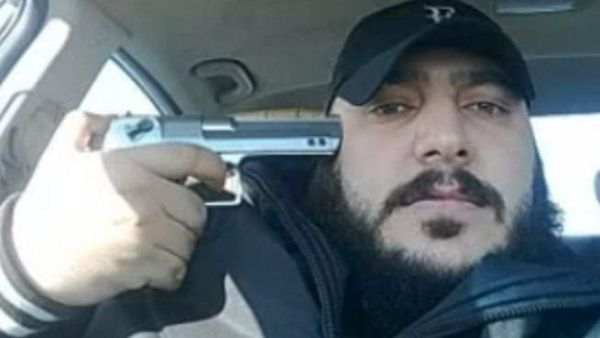 One member of the Shabiha posing with his gun - source The Daily Mail 