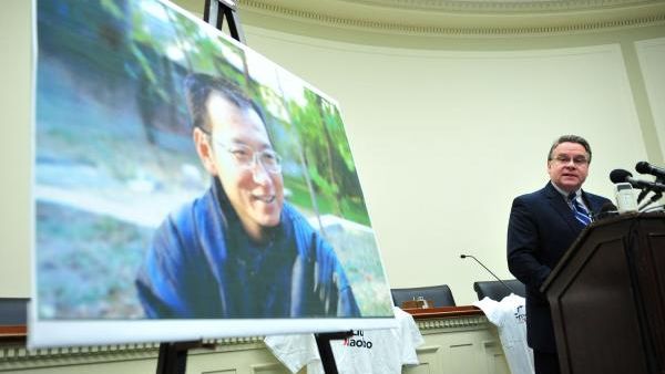 U.S. Rep. Christopher Smith honouring Liu Xiaobo (pictured in the background). (Kevin Dietich / UPI)